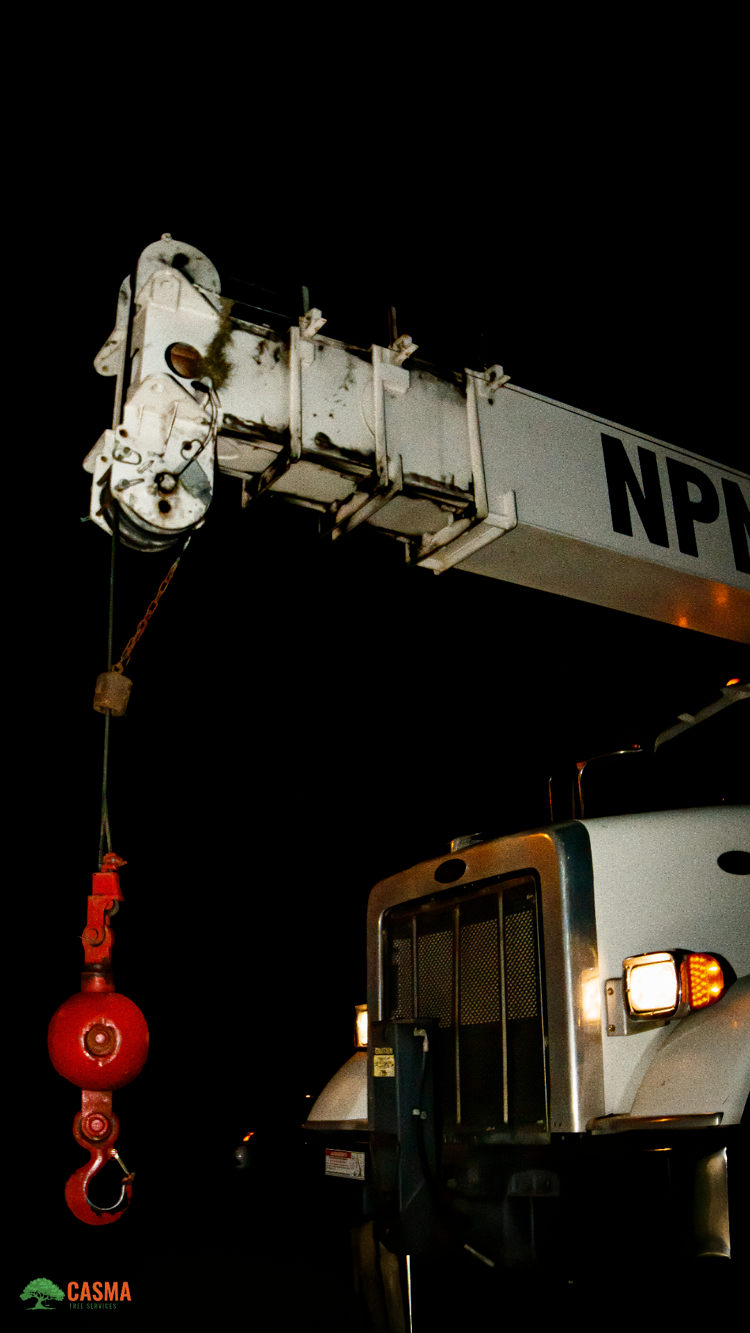 NPN crane boom and hook lit up at night on a Casma job